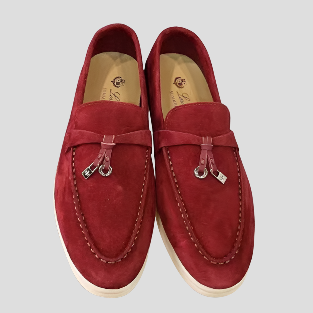 Textured leather women's slip-on loafers with elegant tassels, perfect for casual chic or professional wear.