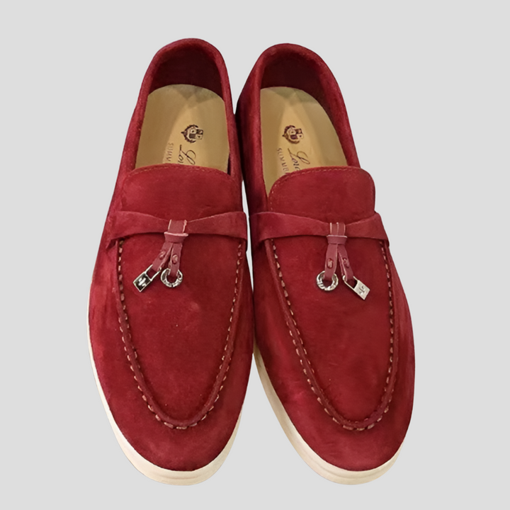 Textured leather women's slip-on loafers with elegant tassels, perfect for casual chic or professional wear.