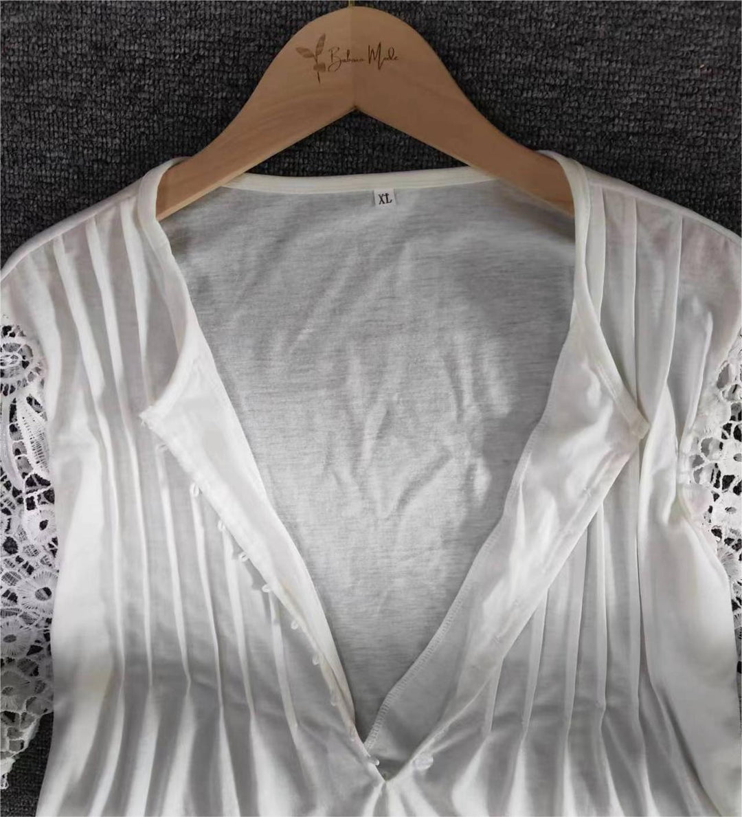 Stylish women's solid long sleeve top, elegant lace trim at neckline, comfortable cotton blend.