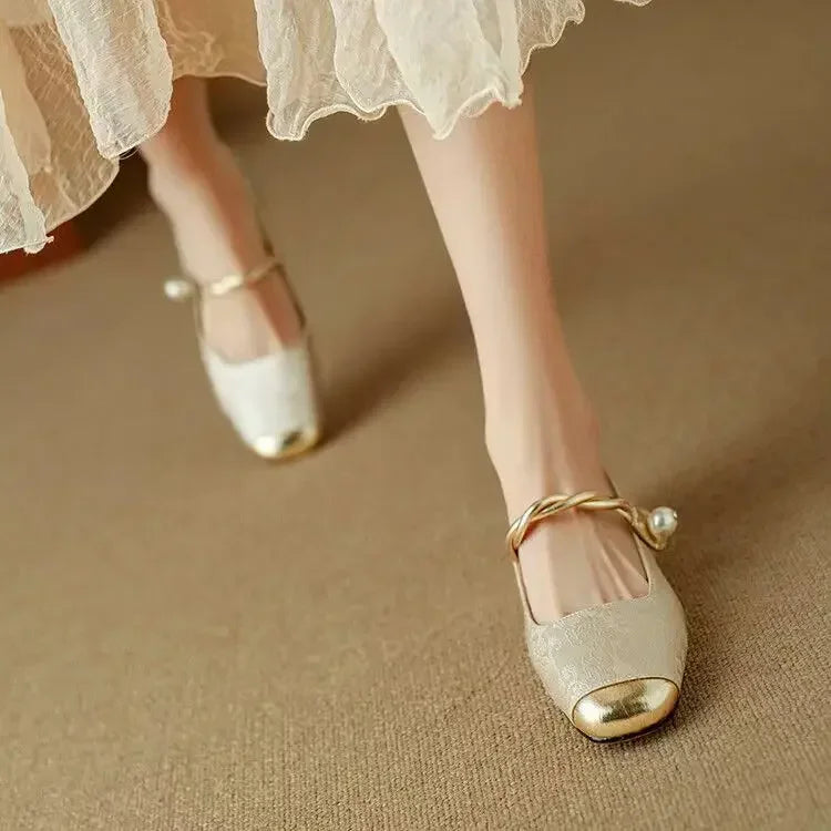 Women's sparkling Mary Janes with a distinct metallic toe, pearl strap & low block heel. Vintage style.