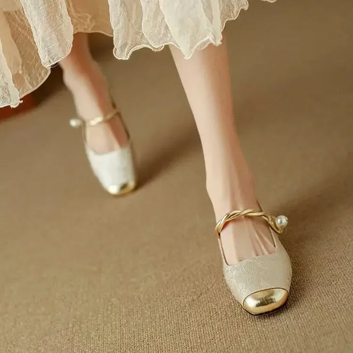 Women's sparkling Mary Janes with a distinct metallic toe, pearl strap & low block heel. Vintage style.