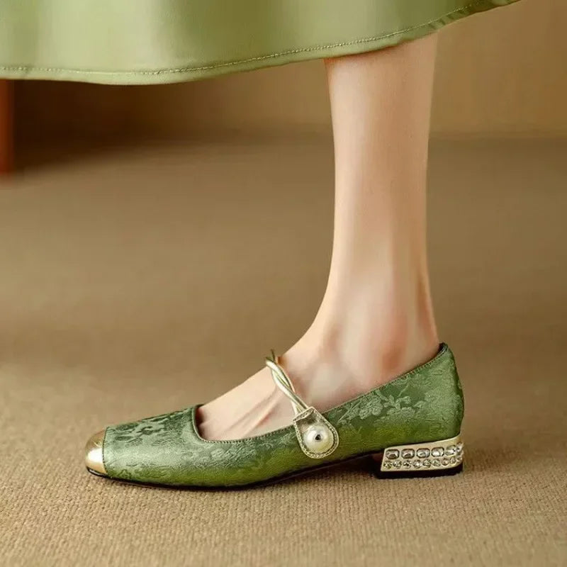 Green sparkling Mary Janes for women, featuring a chic pearl strap & metallic toe, low block heel.