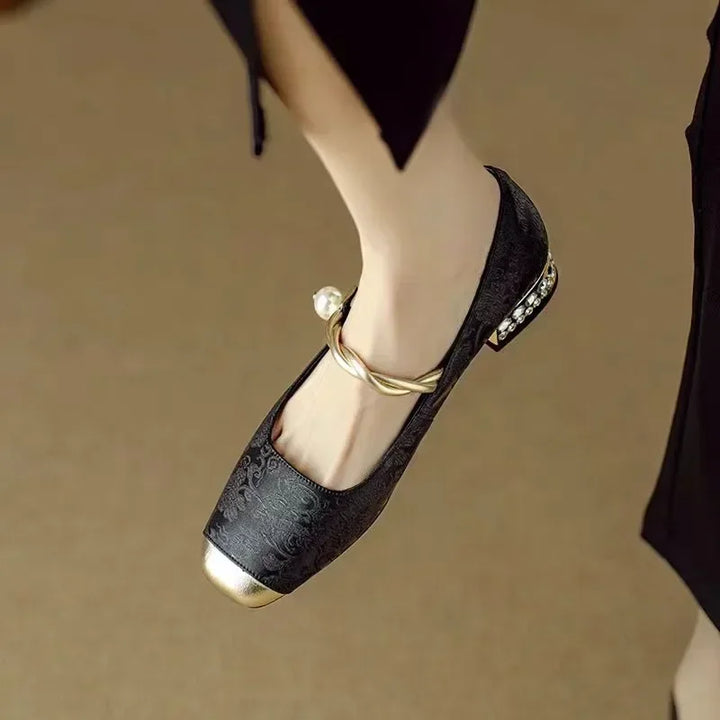 Women's sparkling Mary Janes with a beautiful pearl strap & metallic toe. Elegant low heel footwear.