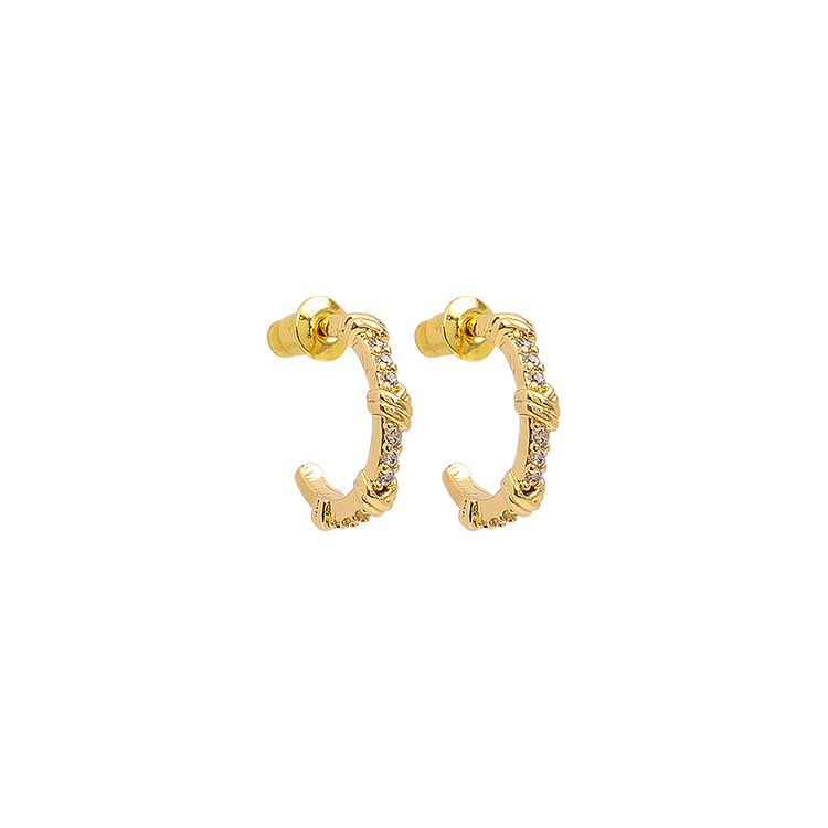 Close-up of sparkling open hoop earrings for women, featuring brilliant gemstones. Stylish and modern.