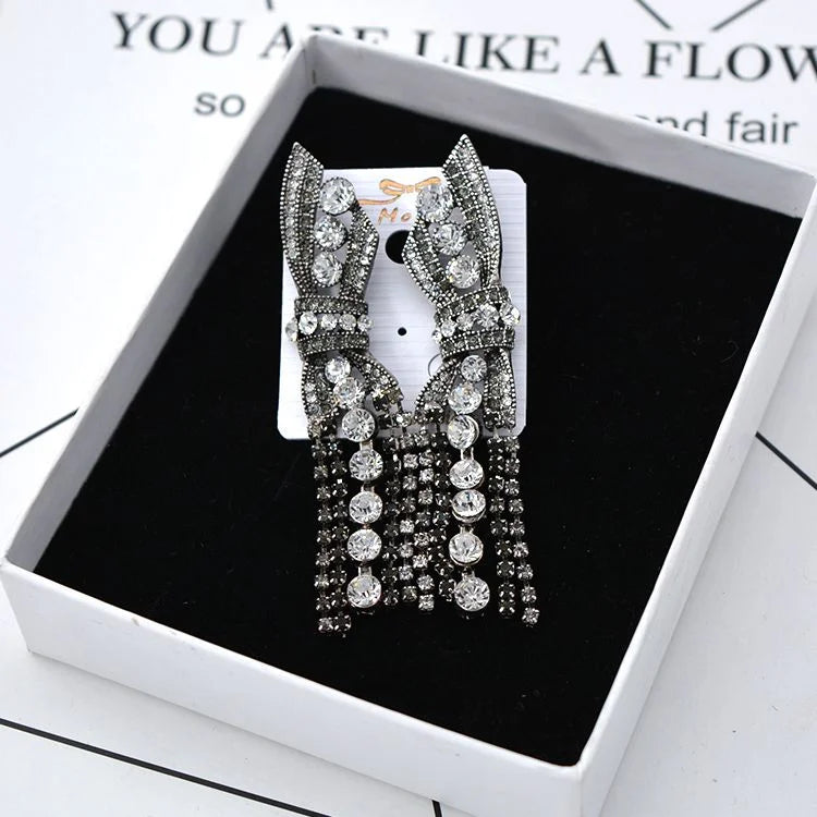 Formal women's jewelry: sparkling butterfly and bow design silver pendant earrings.