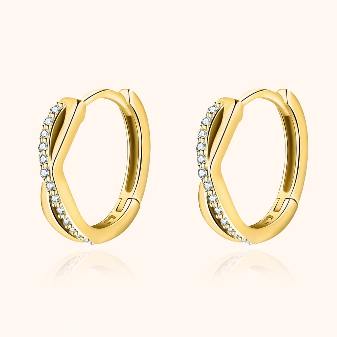 Elegant women's sparkling silver crossed zirconia hoop earrings, perfect jewelry.