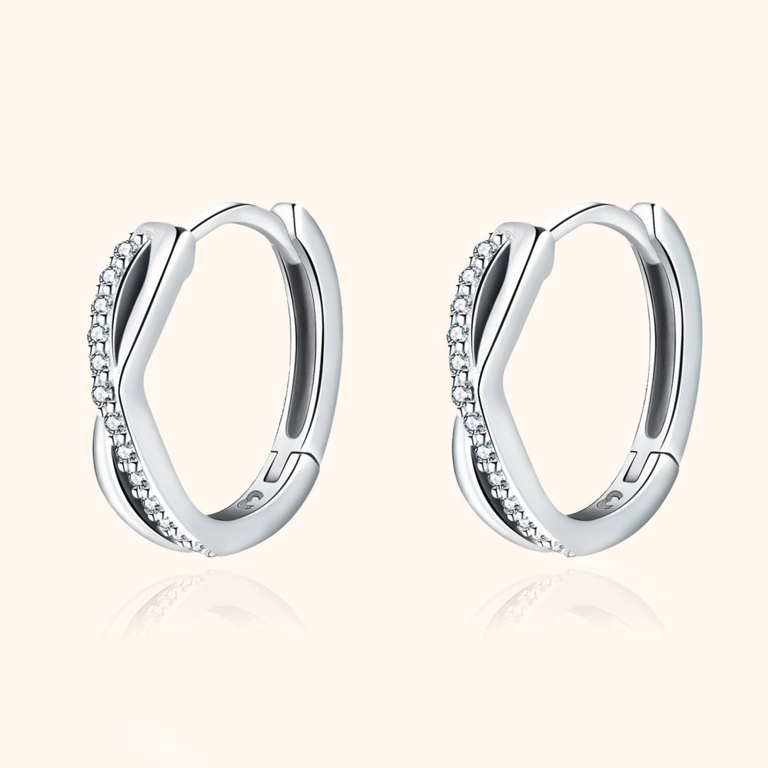 Luxurious women's silver & gold crossed zirconia earrings, adding a sparkling touch.