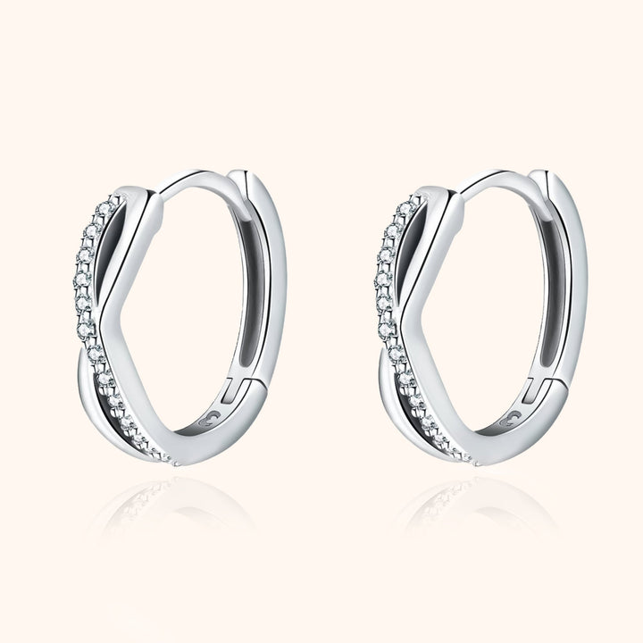 Luxurious women's silver & gold crossed zirconia earrings, adding a sparkling touch.