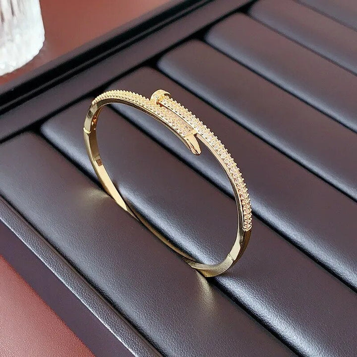 Women's elegant zircon nail bracelet sparkling on wrist, a beautiful fashion accessory for special events.