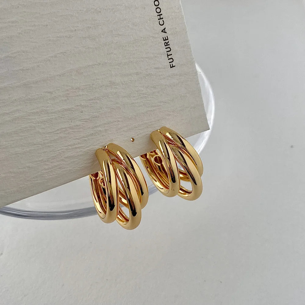 Versatile women's stacked hoop earrings, blending elegant gold and silver tones for any fashion outfit.