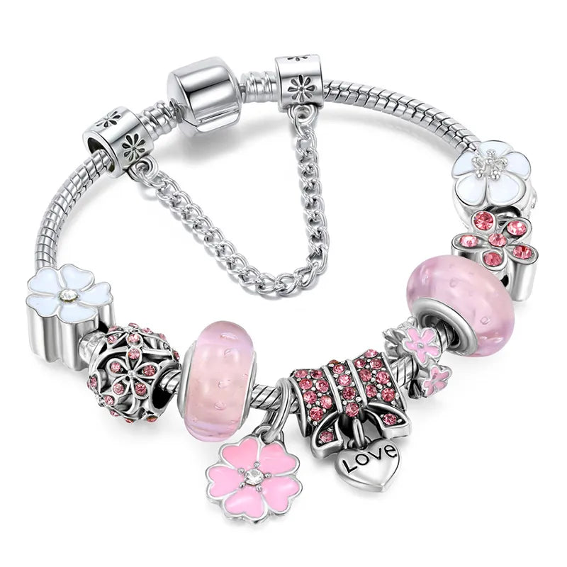 Close-up of a women's peach blossom charm bracelet, a stylish and elegant floral design jewelry piece.