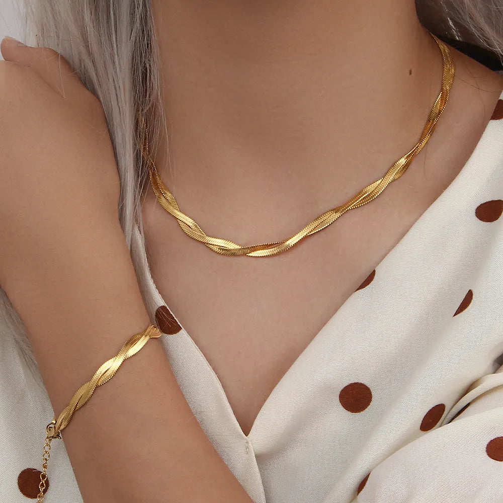 Elegant women's stainless steel twist necklace and matching bracelet set, a perfect jewellery gift accessory.