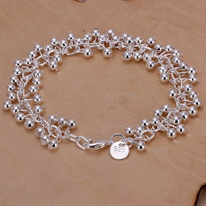 Delicate silver bead bracelet for women, adjustable and ideal for everyday wear or special occasions.