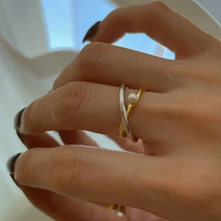 Sterling silver pearl ring for women, featuring a unique crossed design. A timeless and elegant piece.