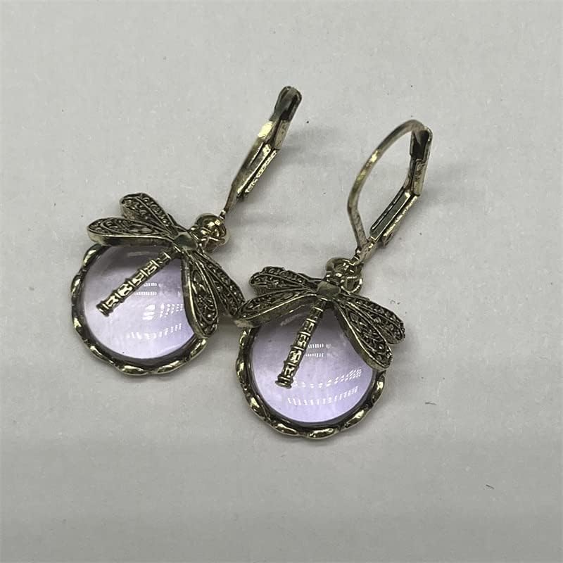 Celestial sterling silver drop earrings featuring a detailed dragonfly and glowing moonstone.