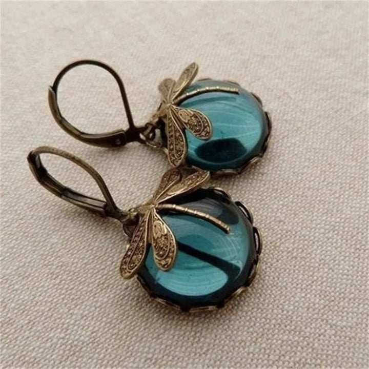 Sparkling moonstone and elegant sterling silver dragonfly drop earrings for a chic look.