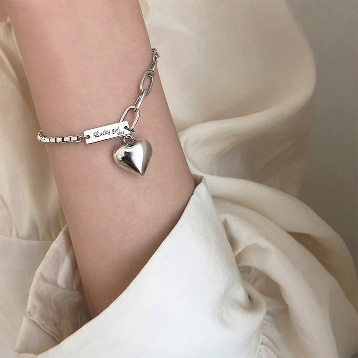 Elegant women's sterling silver heart charm bracelet, a beautiful and dainty jewelry gift.
