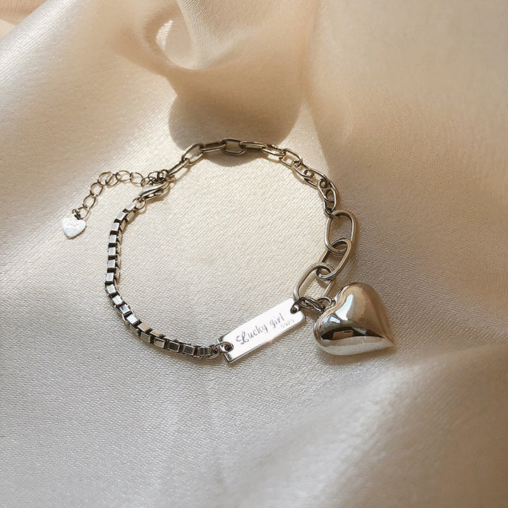 Dainty women's sterling silver heart charm bracelet, perfect elegant jewelry accessory.