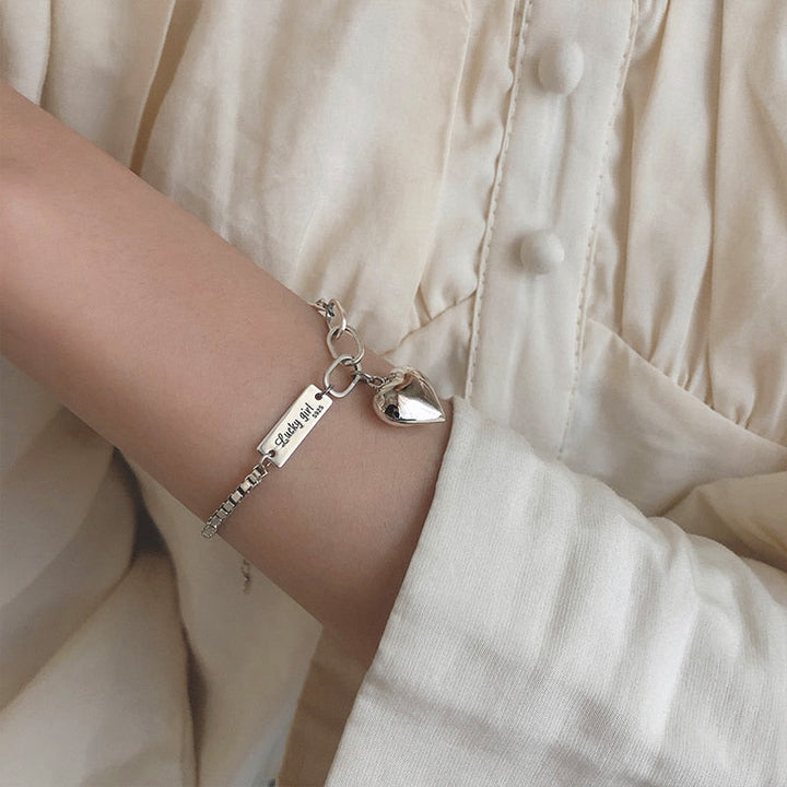 Beautiful sterling silver heart charm bracelet for women, a timeless and elegant gift.
