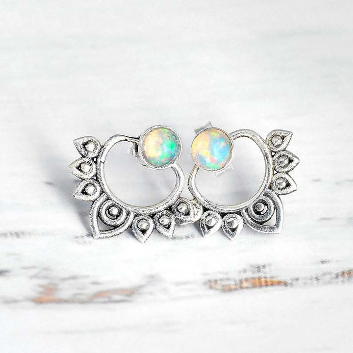Women's shimmering opal lotus earrings in polished sterling silver, a symbolic and elegant jewelry gift.