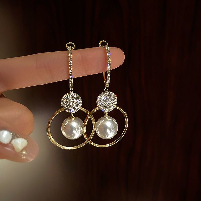 Elegant women's sterling silver pearl drop earrings with sparkling zirconia, perfect for a luxurious, timeless look.