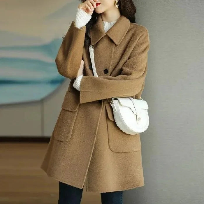 Warm women's double-breasted long winter coat, structured design for elegant cold-weather fashion.