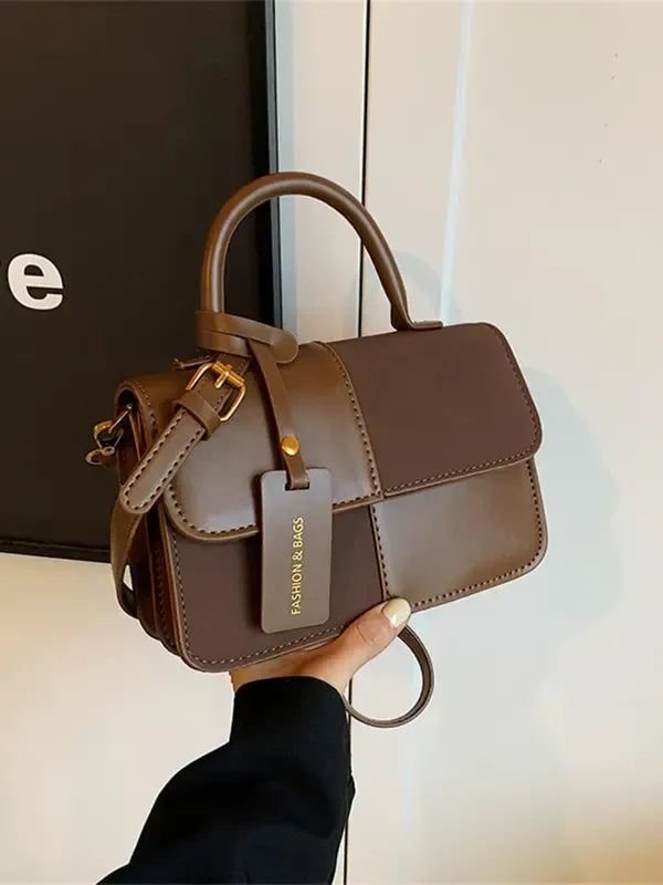 Elegant women's structured top handle bag in a sophisticated color, perfect for daily use and fashion accessory.