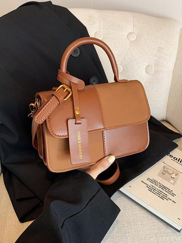 Chic structured top handle bag for women, an elegant and compact fashion accessory suitable for daily and evening wear.