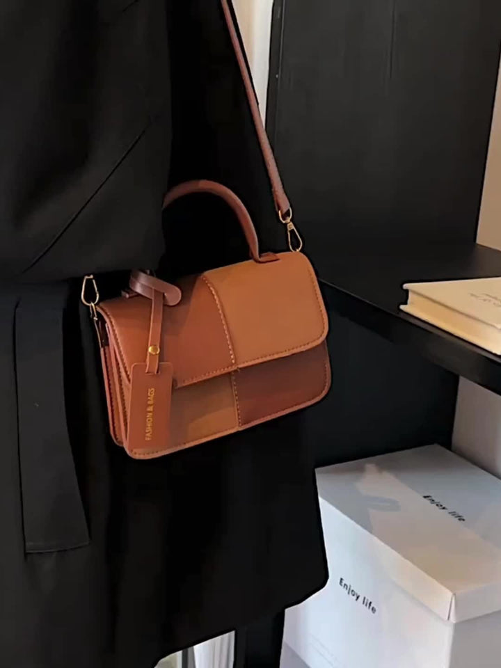 Versatile women's structured top handle bag, an elegant daily handbag and compact fashion accessory for any occasion.