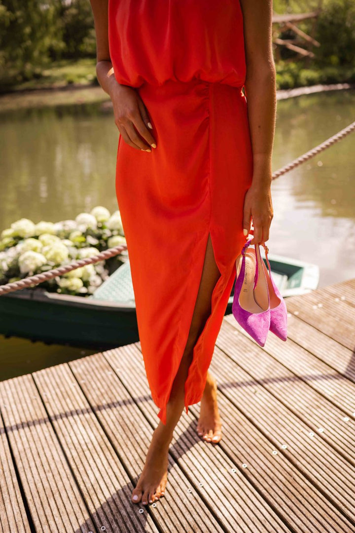 Elegant women's sleeveless midi dress with a flowing skirt, perfect for stylish summer fashion and special events.