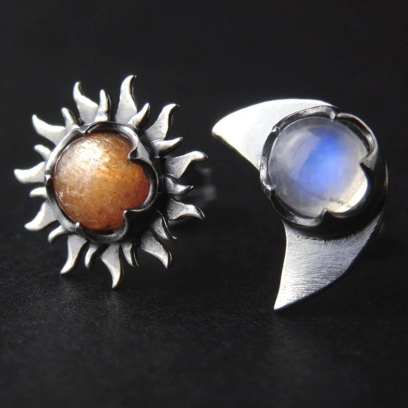 Dangling celestial sun and moon earrings for women. Unique symbolic jewelry accessory with drop design.
