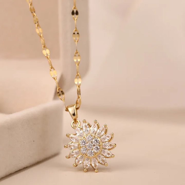 Close-up of an elegant women's sunflower spin duo necklace. Sterling silver rotating floral pendant on an adjustable chain.