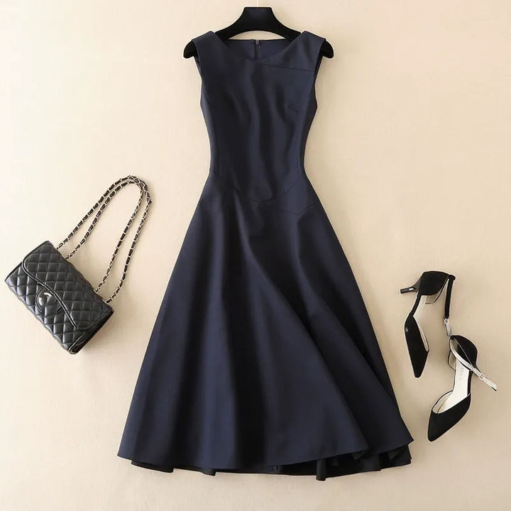 Elegant women's tailored sleeveless dress in navy, perfect for work or cocktail events. Sophisticated fashion.