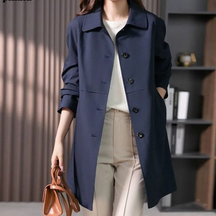 Tailored fit women's trench coat, perfect for professional office wear or chic casual outerwear. Ideal spring/fall fashion.