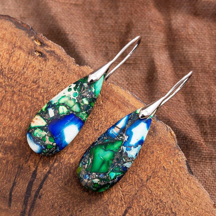 Silver plated teardrop earrings with natural grounding stone. Elegant handmade spiritual jewelry for women.