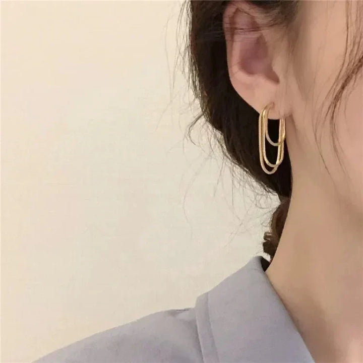Women's three-layer chain drop earrings. Modern layered gold or silver jewelry for a sophisticated look.
