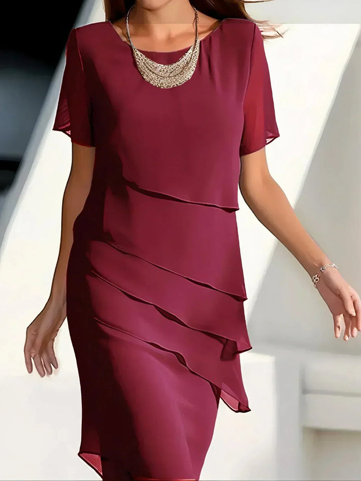 Graceful women's tiered midi dress with elegant layers. Chic and modern fashion for sophisticated events.