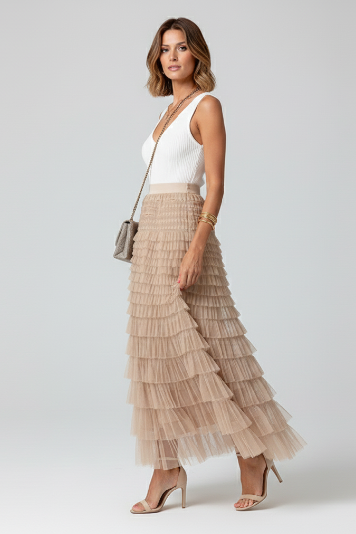 Fashionable women's high-waist tiered tulle midi skirt with delicate ruffles, adding elegance to any outfit.