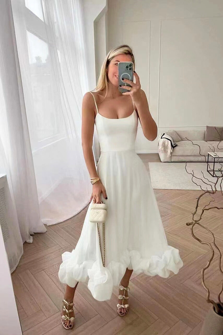 Chic flowing women's dress, ideal as a wedding guest outfit or elegant cocktail party attire.