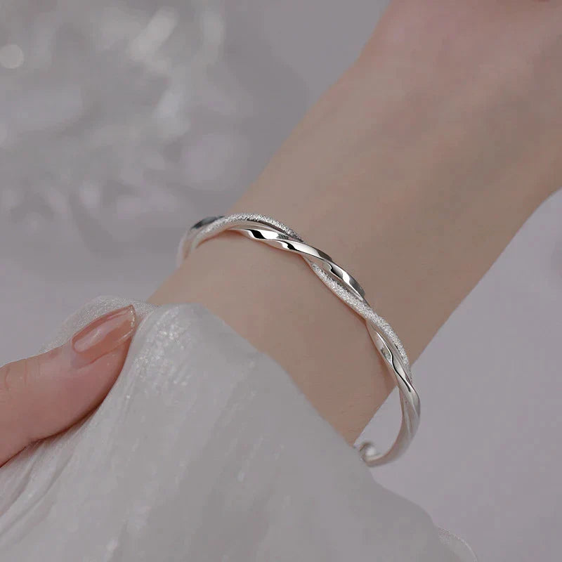 Elegant women's twisted sterling silver bracelet, perfect wrist jewelry for classic style & everyday wear.