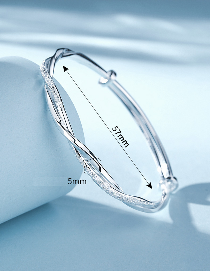 Women's unique twisted sterling silver bracelet, an elegant and versatile wrist jewelry piece.