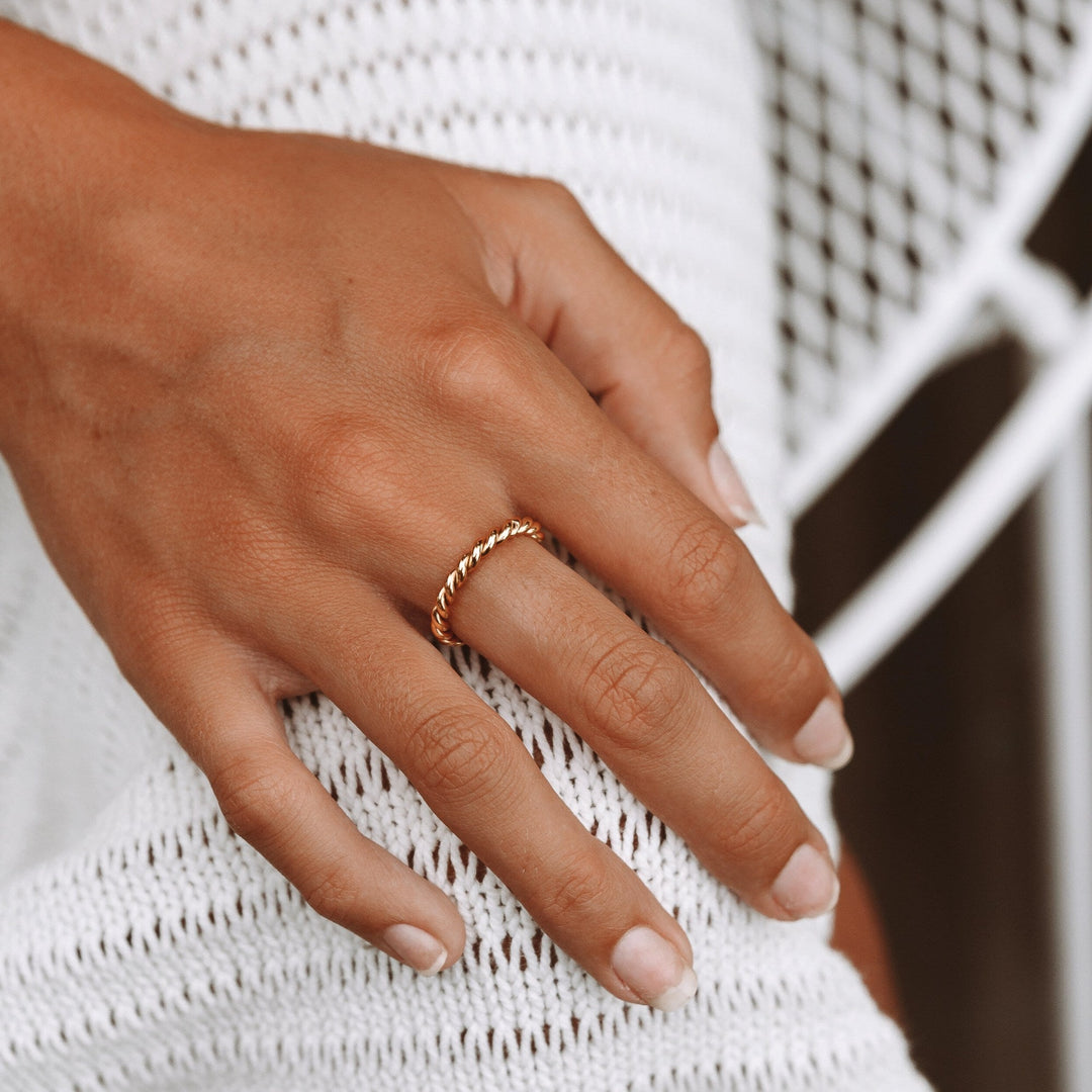 Hypoallergenic gold or silver twisted ring for women, featuring a unique symbolic design. Elegant everyday wear.