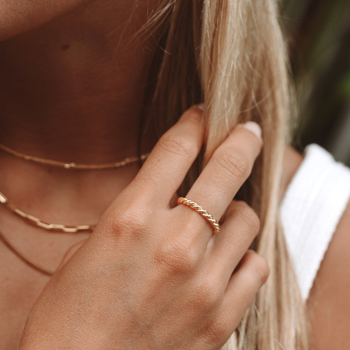 Meaningful women's gold or silver symbolic twisted ring, an elegant jewelry piece representing unity.