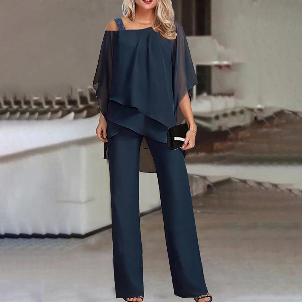 Elegant women's two-piece outfit with cold shoulder top and matching trousers, perfect for party or business casual.