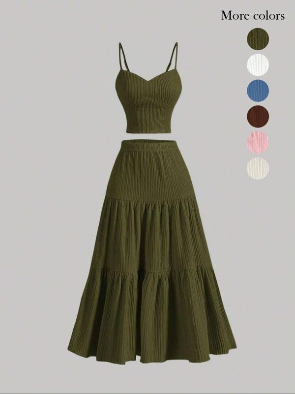 Elegant women's two-piece skirt set with camisole and midi skirt, perfect for a chic summer outfit.