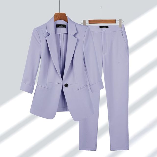 Versatile women's suit with a chic blazer and comfortable trousers, perfect for professional wear.