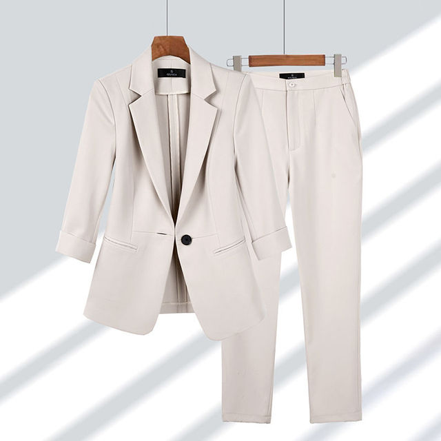 Women's elegant suit featuring a sleek blazer and tailored trousers, ideal for formal or smart casual occasions.
