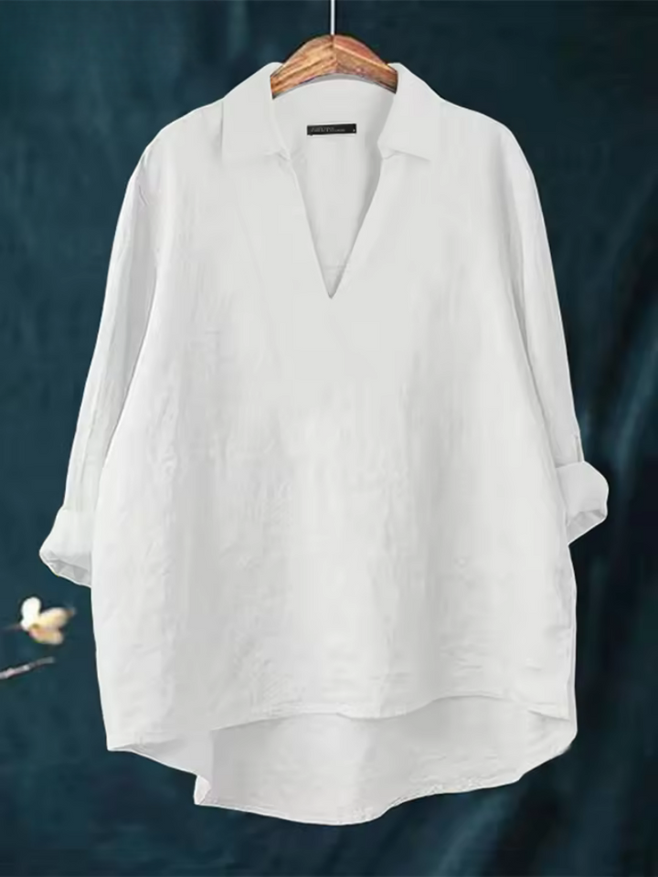 Elegant women's V-neck blouse, perfect for office wear or dressy occasions. Sophisticated fashion top.