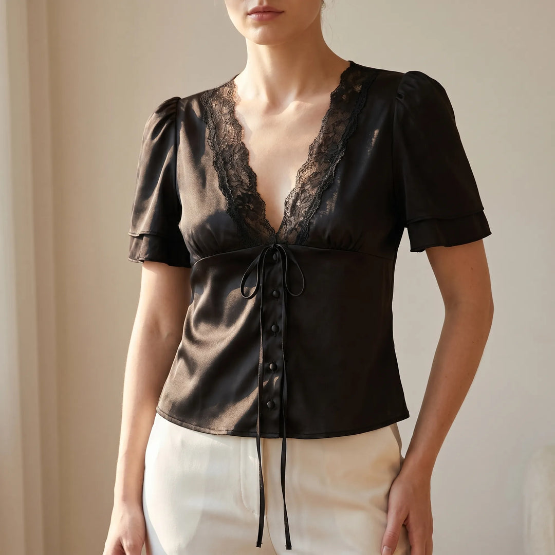 Elegant women's V-neck blouse with delicate lace trim & flutter sleeves. Versatile chic top for day to night.