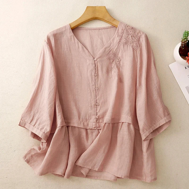 Fashionable women's V-neck top with button front, an elegant blouse for work, everyday wear, and spring/summer style.